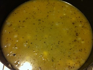 Adding the broth and Tabasco.