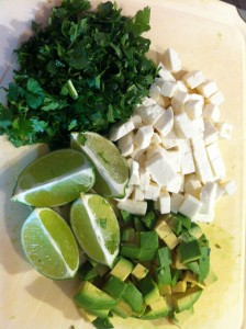 The condiment tray. clockwise from top: chopped cilantro, queso fresco, chopped avocado, limes.