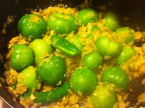Adding the tomatilos to the saucepan.