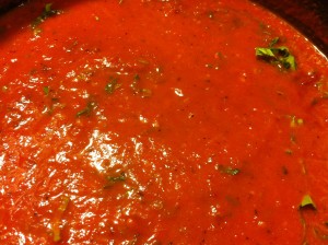 Adding the basil and letting it "steep" in the soup.