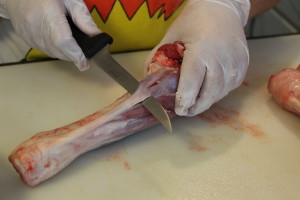 Cleaning the lamb shank. You must remove the silverskin (or have your butcher do it). It doesn't cook down and your meat will be chewy and tough.