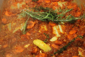 Adding the lemon zest, rosemary, and thyme.