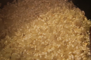 Adding the wine. At this point, constant stirring of the rice will help to release the starch.
