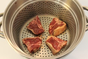 My dad always used chops or shanks in the bottom of the steamer. It adds a lot of flavor to the final dish. Plus, it's an extra treat.